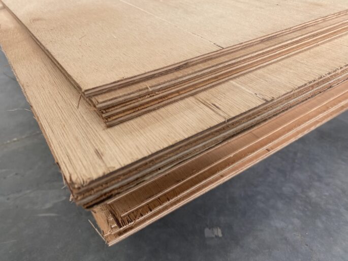 Plywood is made by bonding thin layers of timber veneer with grains at right angles for added strength.
